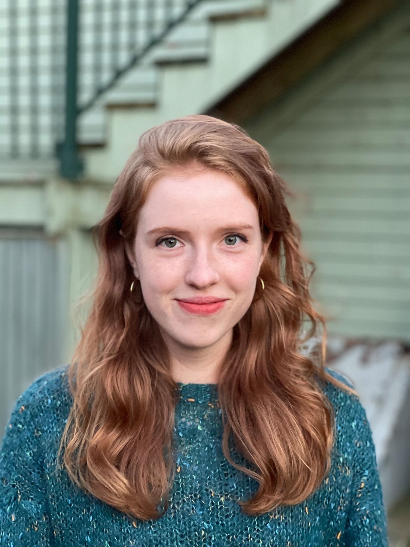 a headshot of Katie Massie, a woman with long red hair and a tutor for Solaris Prep